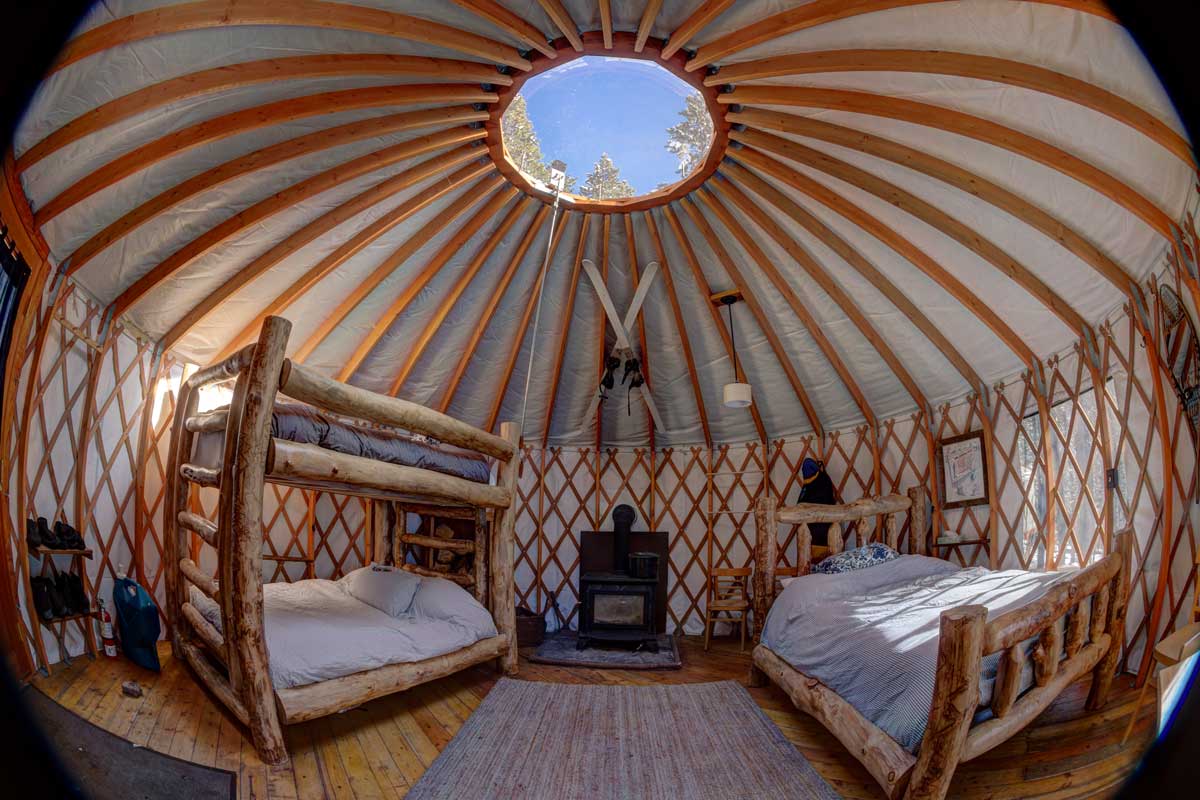 Inside of a sleep yurt with two sets of bunkbeds at Tennessee Pass